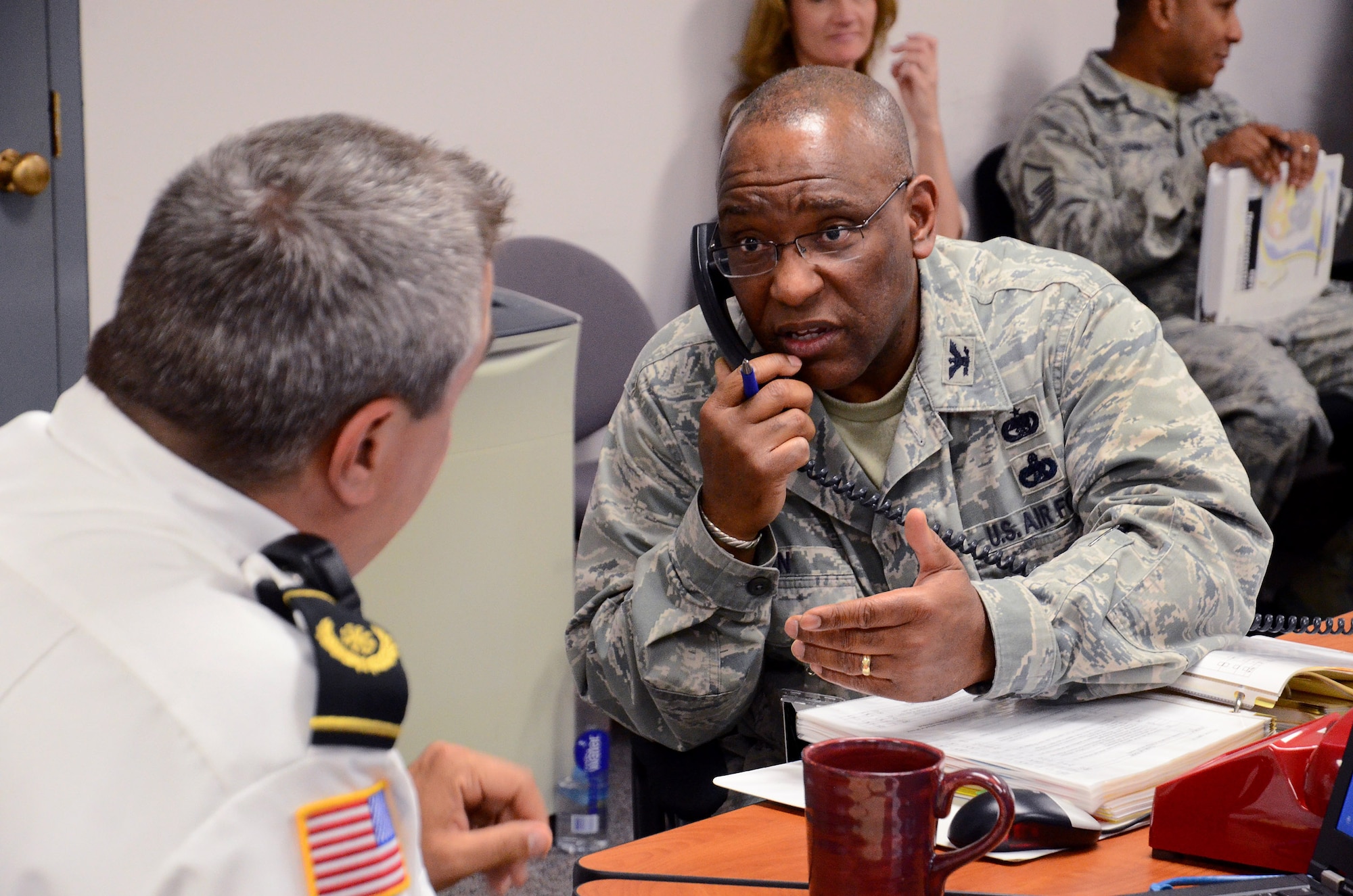 Col. Marshall Irvin, commander, 94th Mission Support Group, relays information from fire department representative, Chief James Kula to the Installation Control Center  during a Major Accident Response Exercise at Dobbins Air Reserve Base, Ga., May 10. The exercise scenario tested the abilities of first responders and key wing leaders and managers to effectively deal with an evolving emergency situation during their 2013 Air Force Reserve Command, Consolidated Unit Inspection. (U.S. Air Force photo/Brad Fallin)