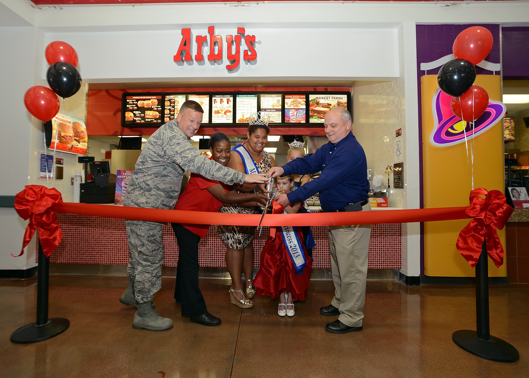 Arby's grand opening and ribbon cutting. From left: Lt. Col. Matthew Wallace, 412th Mission Support Group, deputy group commander; Aleeza Griffin, Arby's manager; the Edwards Queens; and Mike Wiles, Edwards Exchange general manager. (U.S. Air Force photo by Jet Fabara)