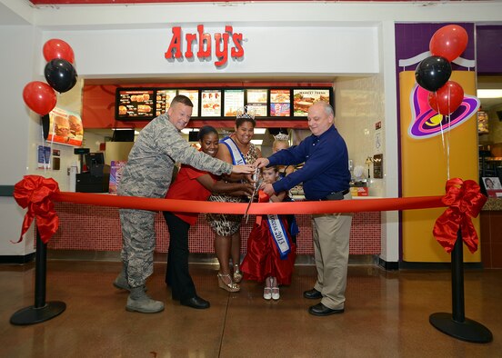 Arby's grand opening and ribbon cutting. From left: Lt. Col. Matthew Wallace, 412th Mission Support Group, deputy group commander; Aleeza Griffin, Arby's manager; the Edwards Queens; and Mike Wiles, Edwards Exchange general manager. (U.S. Air Force photo by Jet Fabara)