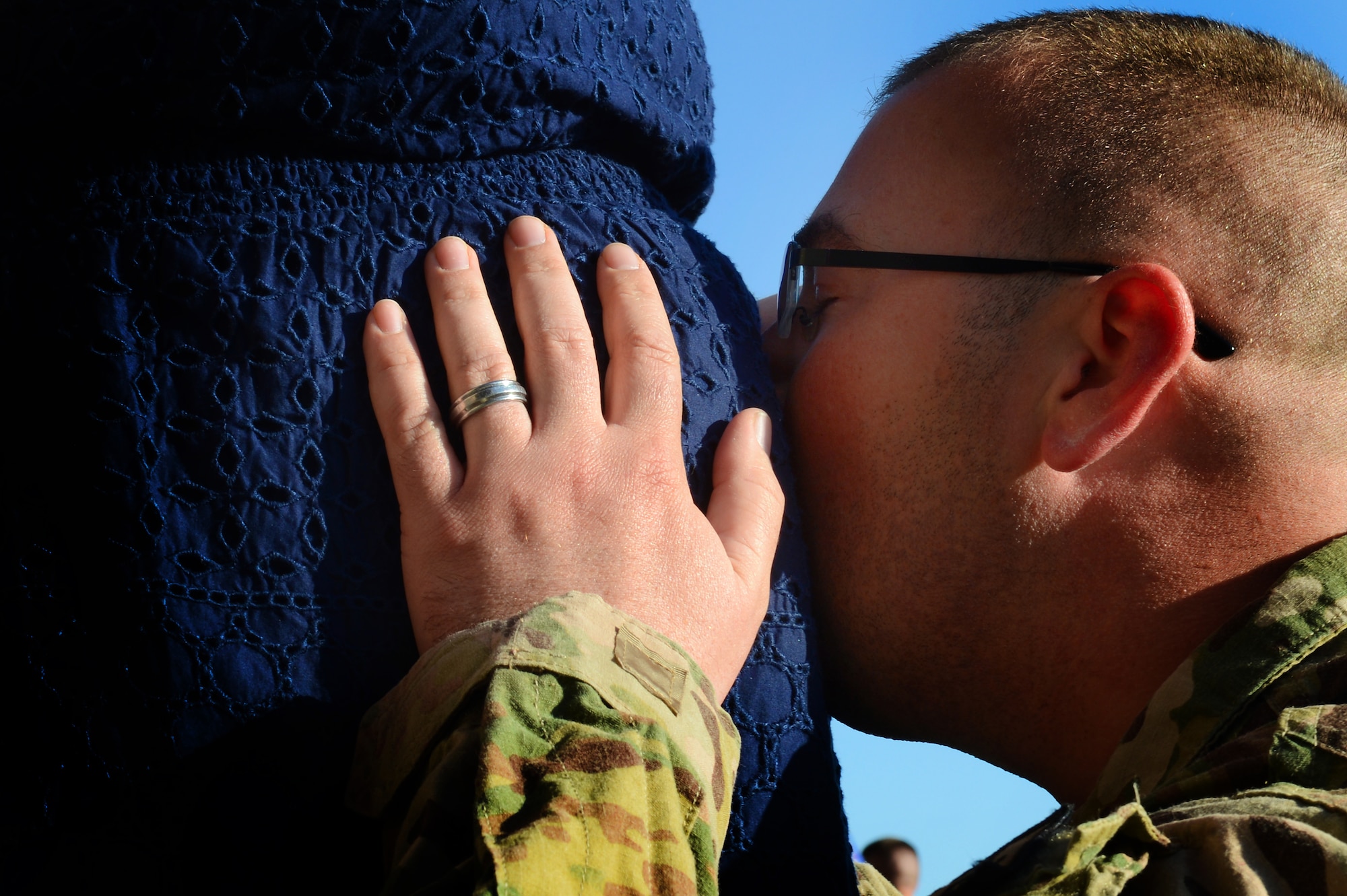 U.S. Air Force Tech. Sgt. Kevin Grabowsky, 20th Equipment Maintenance Squadron production supervisor, kisses his wife’s pregnant tummy after returning from deployment, April 25, 2013, Shaw Air Force Base, S.C. Grabowsky was deployed to Kandahar Airfield, Afghanistan, for six months. While deployed he found out his wife was pregnant with their first child. (U.S. Air Force photo by Airman 1st Class Nicole Sikorski/Released)  