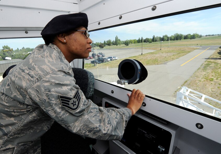 Staff Sgt. Denine Deal, 92nd Security Forces Squadron police services, scans the area for training purposes from the inside of a skywatch tower at Fairchild Air Force Base, Wash., June 11, 2013. SSgt Deal has been selected as a member of Fairchild’s Finest. (U.S. Air Force photo by Airman 1st Class Ryan Zeski)