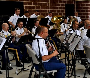 Members of the U.S. Army Training and Doctrine Command Band warm up for the “Music Under the Stars” kickoff event, June 6, 2013, at Fort Eustis, Va. The band is celebrating their 81st year of hosting the free summer concert series. (U.S. Air Force photo by Staff Sgt. Wesley Farnsworth / Released) 