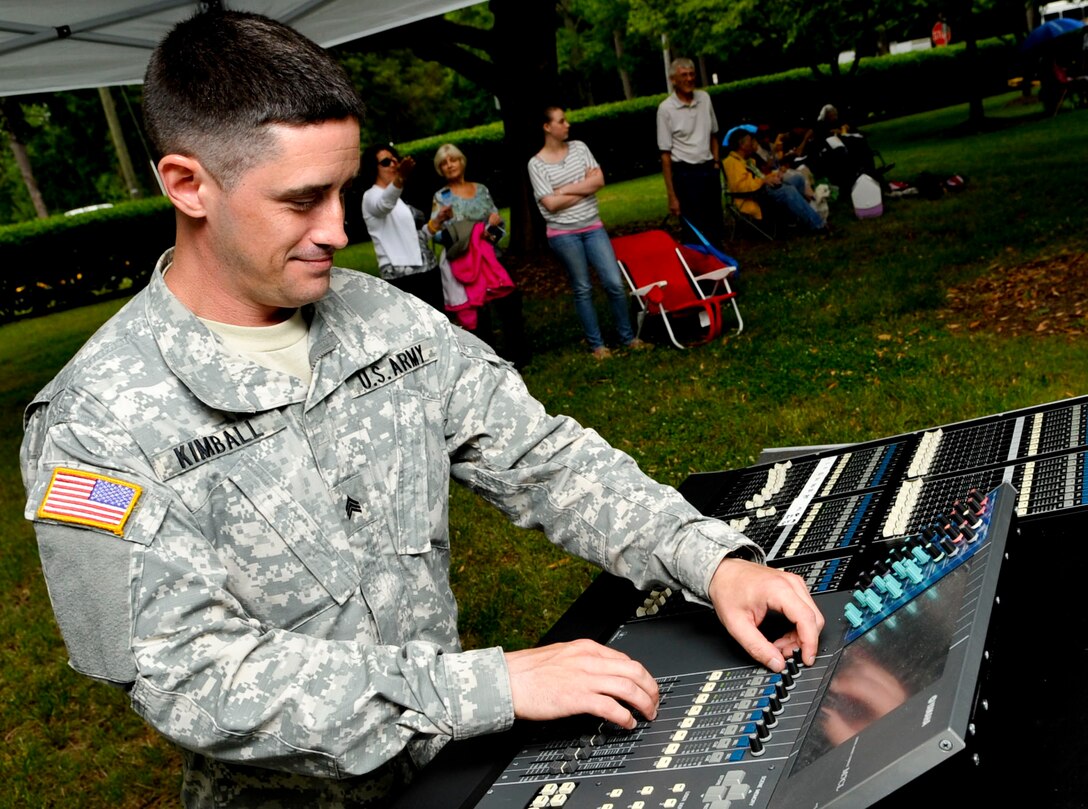 U.S. Army Sgt. Eruch Kimball, U.S. Army Training and Doctrine Command Band sound engineer, makes adjustments prior to the start of the “Music Under the Stars” kickoff event, June 6, 2013, at Fort Eustis, Va. The band is celebrating their 81st year of hosting the free summer concert series. (U.S. Air Force photo by Staff Sgt. Wesley Farnsworth / Released) 