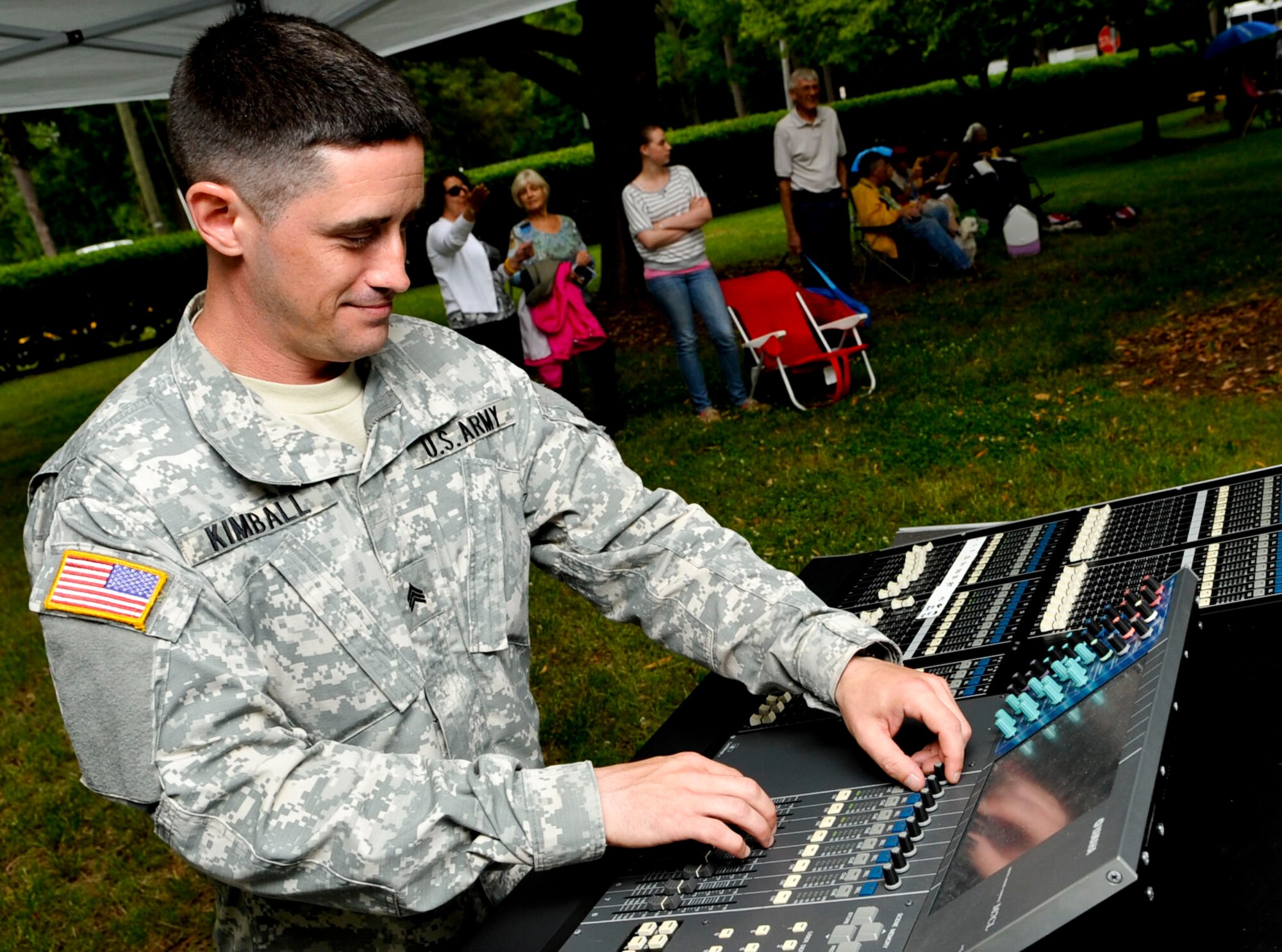 U.S. Army Sgt. Eruch Kimball, U.S. Army Training and Doctrine Command Band sound engineer, makes adjustments prior to the start of the “Music Under the Stars” kickoff event, June 6, 2013, at Fort Eustis, Va. The band is celebrating their 81st year of hosting the free summer concert series. (U.S. Air Force photo by Staff Sgt. Wesley Farnsworth / Released) 