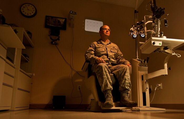 U.S. Air Force Master Sgt. David Sims, 57th Aircraft Maintenance Squadron first sergeant, waits for Capt. (Dr.) William Catt, 99th Aerospace Medicine chief of aerospace optometry, to complete his examination during an annual eye exam June 7, 2013, at Nellis Air Force Base, Nev. If the eye exam determines that your eyesight has changed, the optometrist will prescribe new glasses. (U.S. Air Force photo by Senior Airman Daniel Hughes)