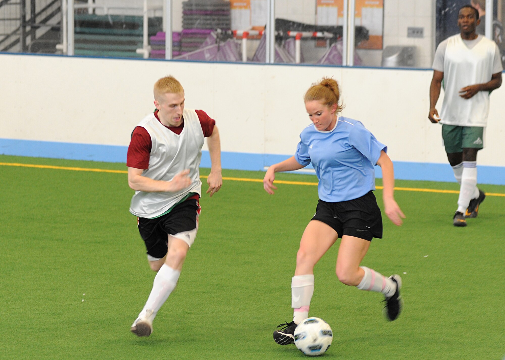 A member of the 319th Logistics Readiness Squadron soccer team (left) runs to steal the soccer ball from the opponent during the intramural soccer championship, May 30, 2013, at the Fitness Center, on Grand Forks Air Force Base, N.D.  LRS defeated their rivals 4-3. (U.S. Air Force photo/Airman 1st Class Xavier Navarro)