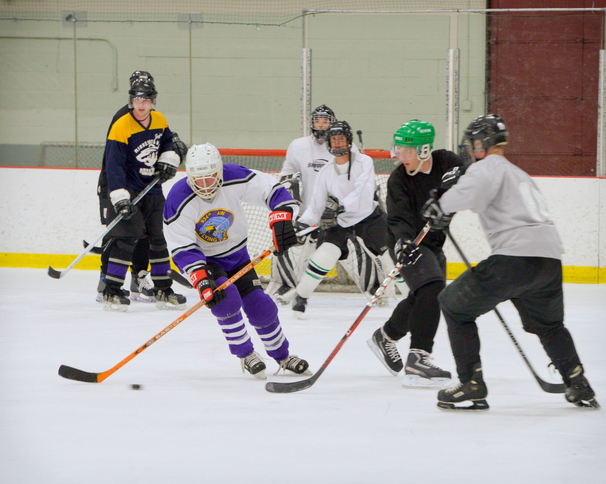 Members of the 934th Airlift Wing play against each other in a friendly game of hockey at the Wakota Civic Arena after the June Unit Training Assembly weekend.  (U.S. Air Force photo/Shannon McKay)