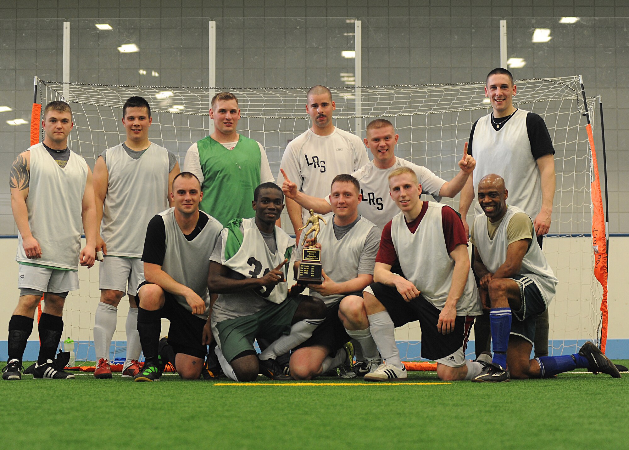 The 319th Logistics Readiness Squadron soccer team poses with the championship trophy after winning the intramural soccer championship match, May 30, 2013, at the Fitness Center on Grand Forks Air Force Base, N.D. LRS defeated their opponents team 4-3. (U.S. Air Force photo/Airman 1st Class Xavier Navarro)