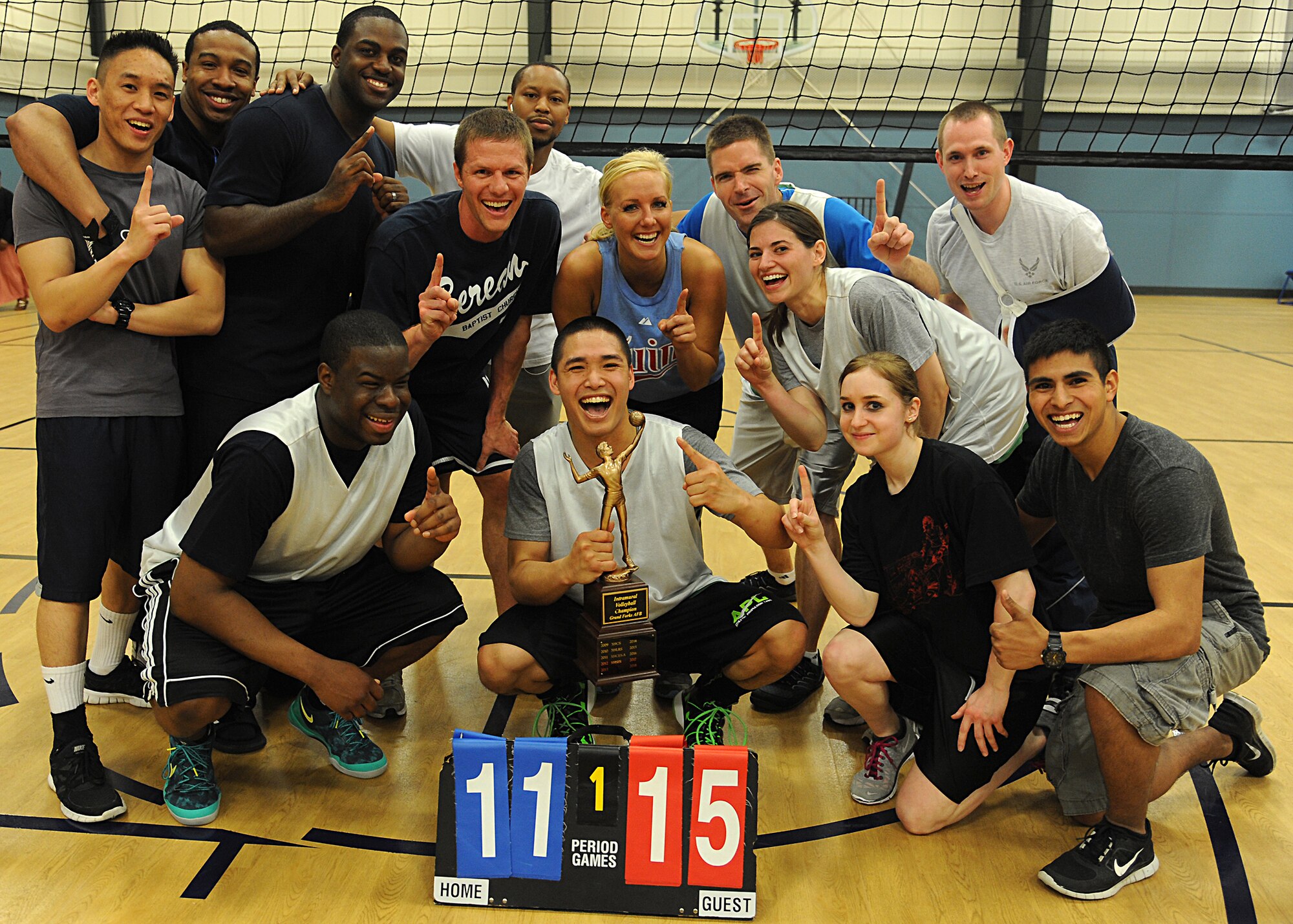 The 319th Medical Group volleyball team poses with the championship trophy after winning the intramural volleyball championship match against the 319th Civil Engineer Squadron, May 29, 2013, at the Fitness Center, on Grand Forks Air Force Base, N.D.  The Med Group defeated the 319th CES 15-11. (U.S. Air Force photo/Airman 1st Class Xavier Navarro)