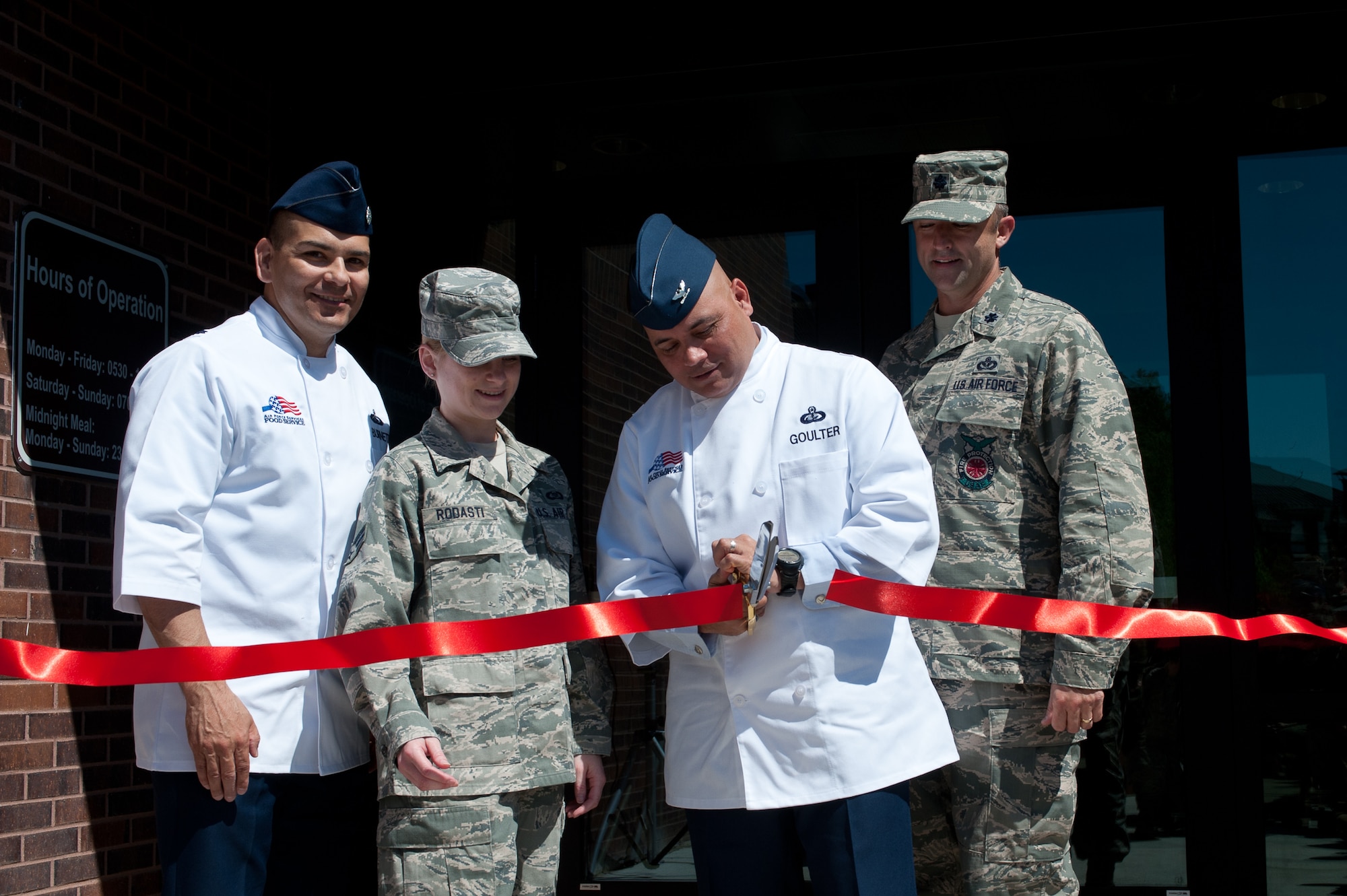 Col. Thomas Goulter Jr., 28th Mission Support Group commander, cuts the ribbon to the base’s newly- renovated dining facility - the Raider Café - during a special ceremony at Ellsworth Air Force Base, S.D., June 6, 2013. The new facility features many new amenities designed to provide diners with healthy meal options in a modern, state-of-the-art dining atmosphere. (U.S. Air Force photo by Airman 1st Class Alystria Maurer/Released)