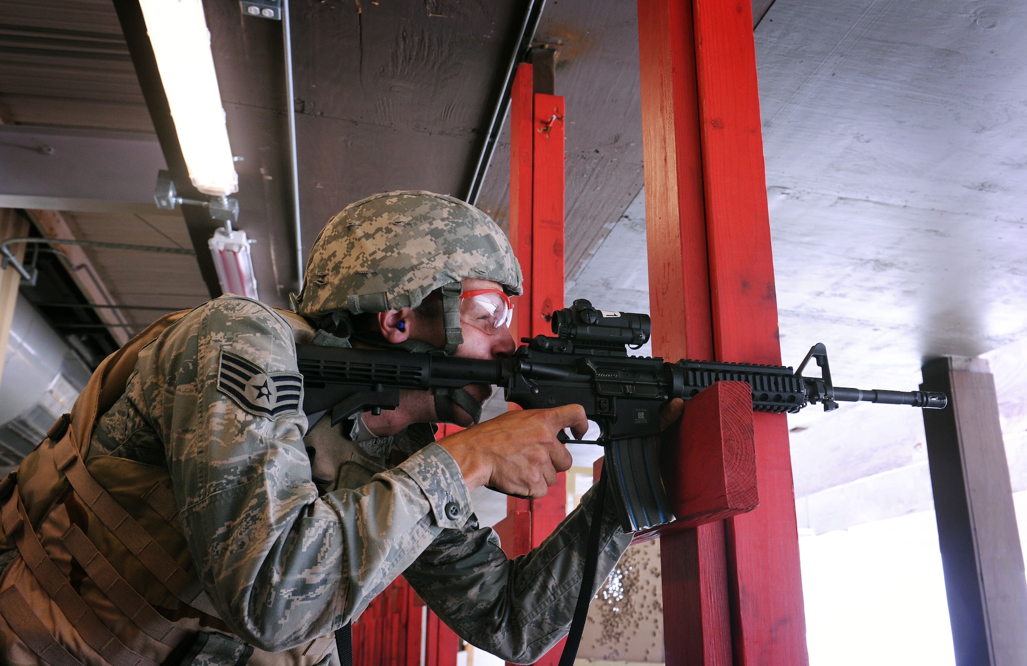 A Combat Arms Training and Maintenance student holds his weapon on a target at the firing range at Scott Air Force Base, Ill. June 10, 2013. CATM teaches the basic firing positions, which consist of lying down with a support, lying down without a support, kneeling with a support and standing behind a barricade; most of which is learned from basic training. CATM is divided into three “tables”. The number of tables an Airman has to complete depends on his deployed location and professional duties. (U.S. Air Force photo/Airman 1st Class Jaeda Waffer)
