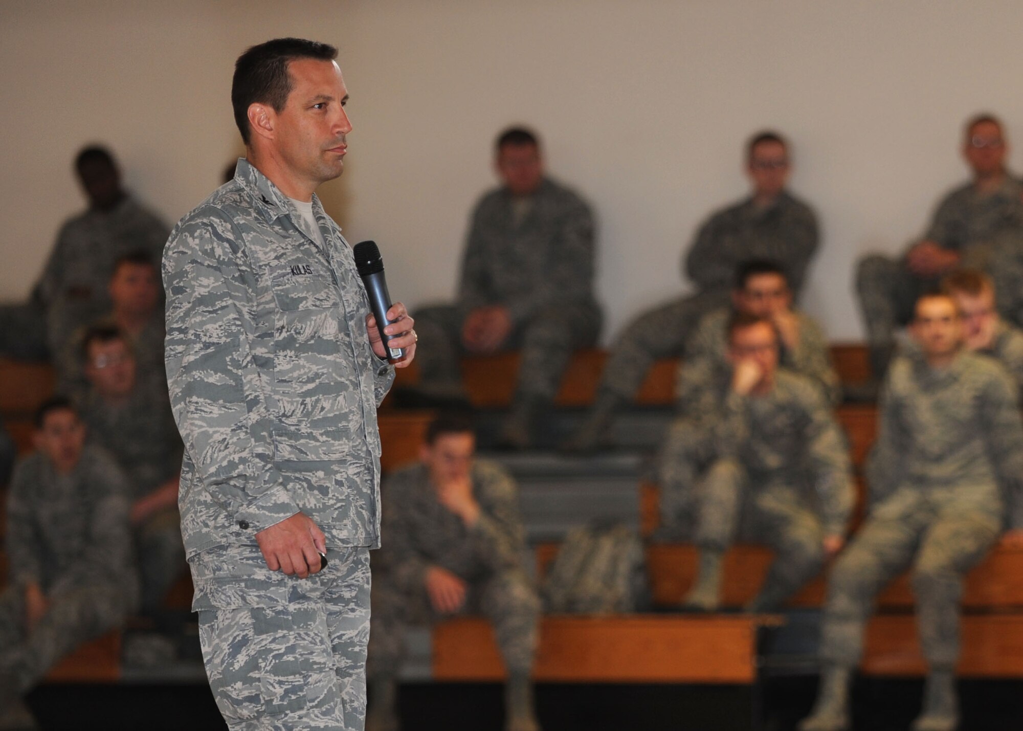 Col. Christopher Kulas, 100th Air Refueling Wing commander, delivers a Team Mildenhall commander’s call June 11, 2013, in the Hardstand Fitness Center on RAF Mildenhall, England. The commander’s call, held four times throughout the day, covered events from the last quarter, safety and enlisted career progression. (U.S. Air Force photo by Airman 1st Class Preston Webb/Released)