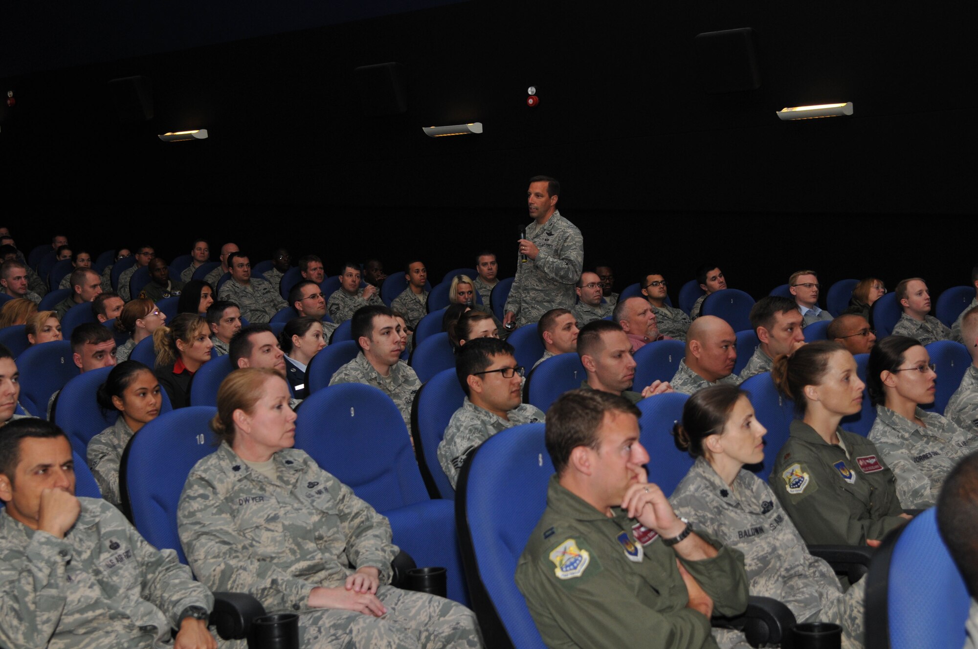 Col. Christopher Kulas, 100th Air Refueling Wing commander, goes over slides with members of Team Mildenhall during a commander’s call June 11, 2013, at the base theater on RAF Mildenhall, England. The commander’s call, held four times throughout the day, was Kulas’ last on RAF Mildenhall. (U.S. Air Force photo by Airman 1st Class Kelsey Waters/Released)