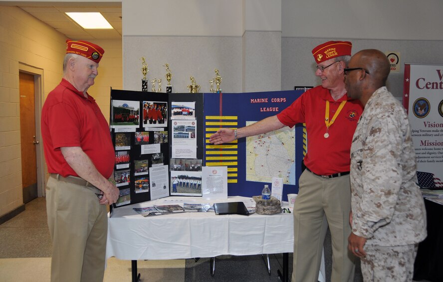 Members of the Marine Corps League, the congressionally chartered Marine Corps veterans’ organization, speak to Gunnery Sgt. Carlos Culbreath regarding the various outreach programs the league has been involved in over the past year. Over 180 Marines in the Individual Ready Reserve program were selected to attend the 2013 Marine IRR Muster on June 9 at the Navy Operations Support Center here. (U.S. Air Force photo/Senior Airman Elizabeth Van Patten)