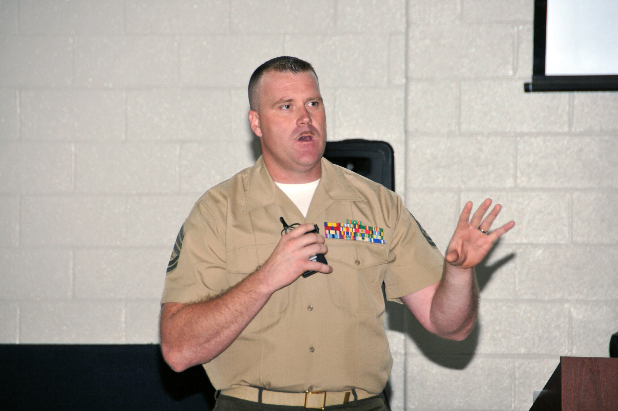 Gunnery Sgt. Arthur Mueller, 2013 Individual Ready Reserve Muster emcee, speaks to Marines on their benefits and options on June 9 at the Navy Operations Support Center here. Over 180 Marines in the Individual Ready Reserve program were selected to attend the 2013 Marine IRR Muster. (U.S. Air Force photo/Senior Airman Elizabeth Van Patten)