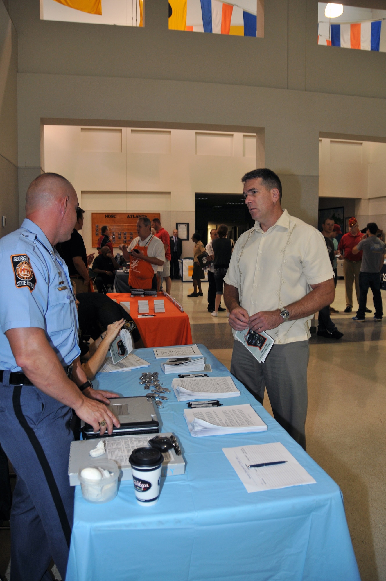 A Marine is briefed on several potential job opportunities with the Georgia State Patrol. Over 180 Marines in the Individual Ready Reserve program were selected to attend the 2013 Marine IRR Muster on June 9 at the Navy Operations Support Center here. (U.S. Air Force photo/Senior Airman Elizabeth Van Patten)