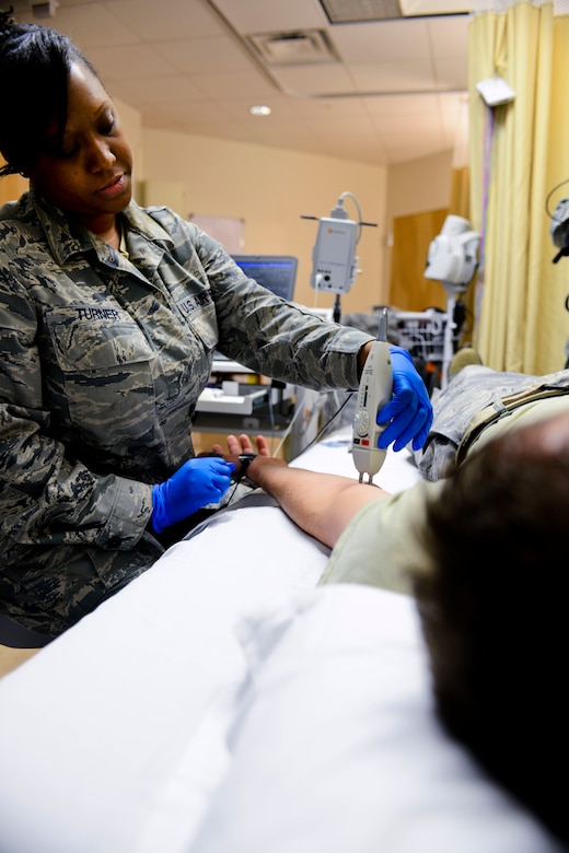 U.S. Air Force Staff Sgt. Tameka Turner, 633rd Medical Operations Squadron Neurology Clinic technician, practices a nerve conduction study on a fellow medical technician at U.S. Air Force Hospital Langley at Langley Air Force Base, Va., May 4, 2013. The staff plans to increase availability to patients by including an additional neurologist and expanding services provided through obtaining certifications in electromyography (EMG), a study used to measure electrical activity in a patient’s muscles, and nerve conduction studies, a test commonly used to evaluate function of motor and sensory nerves.  (U.S. Air Force photo by Airman 1st Class R. Alex Durbin/Released)