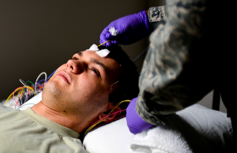 U.S. Air Force Tech. Sgt. Valarie Platt, 633rd Medical Operations Squadron Neurology Clinic noncommissioned officer in charge, removes electrodes from the head of Airman 1st Class Christopher Howell, 633rd MDOS medical technician, after an electroencephalography (EEG) study at U.S. Air Force Hospital Langley at Langley Air Force Base, Va., May 4, 2013. Neurology is the medical specialty that deals with the anatomy, function and disorders of the nervous system, including the brain, spinal cord, nerves and muscles. (U.S. Air Force photo by Airman 1st Class R. Alex Durbin/Released)