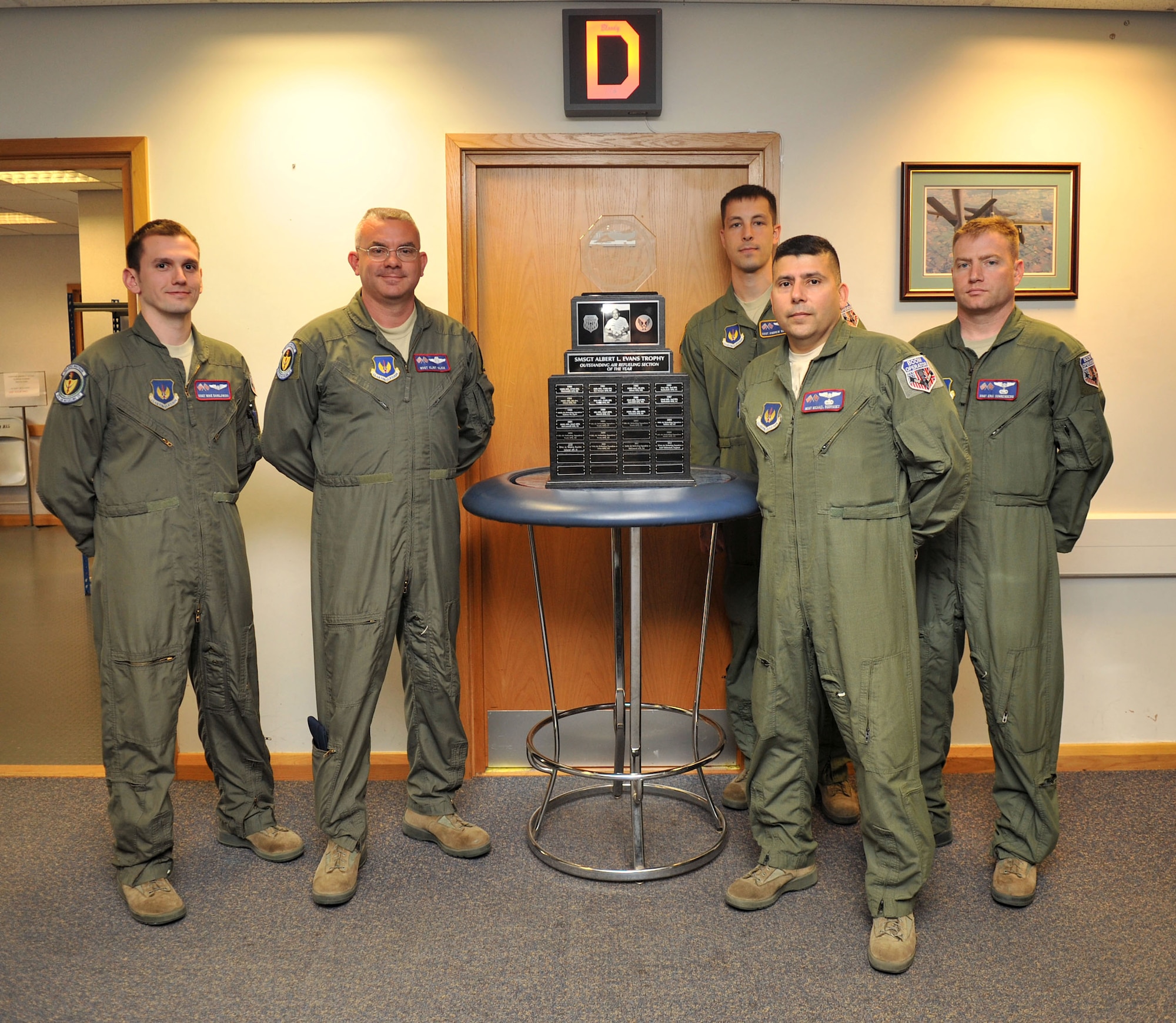 Boom operators from the 351st Air Refueling Squadron pose for a group photo following the unveiling of the Senior Master Sgt. Albert L. Evans Outstanding Refueling Section of the Year award June 11, 2013, at RAF Mildenhall, England. The award recognizes the best of more than 50 boom operator teams in the Air Force. (U.S. Air Force photo by Staff Sgt. Jerilyn Quintanilla/Released)