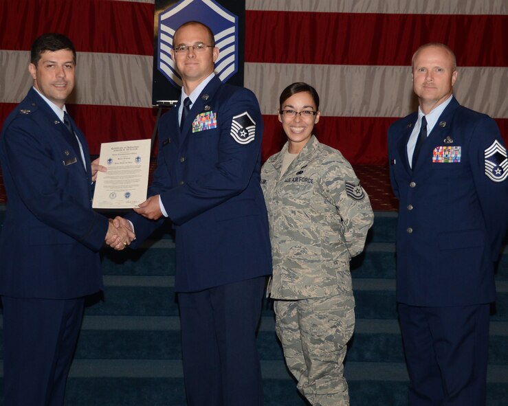 Master Sgt. Joseph Mueller, 2nd Civil Engineer Squadron, receives a certificate of promotion to master sergeant from Col. Andrew Gebara, 2nd Bomb Wing commander, during the June Wing Promotion Ceremony on Barksdale Air Force Base, La., June 3, 2013. (U.S. Air Force photo/Staff Sgt. Amber Corcoran)
