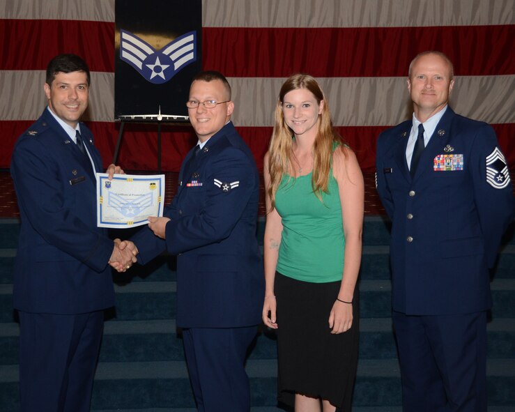 Airman 1st Class Dwight Turner, 2nd Aircraft Maintenance Squadron, receives a certificate of promotion to senior airman from Col. Andrew Gebara, 2nd Bomb Wing commander, during the June Wing Promotion Ceremony on Barksdale Air Force Base, La., June 3, 2013. (U.S. Air Force photo/Staff Sgt. Amber Corcoran)