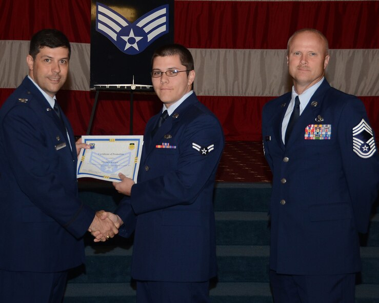 Airman 1st Class Stephen Cole, 2nd Aircraft Maintenance Squadron, receives a certificate of promotion to senior airman from Col. Andrew Gebara, 2nd Bomb Wing commander, during the June Wing Promotion Ceremony on Barksdale Air Force Base, La., June 3, 2013. (U.S. Air Force photo/Staff Sgt. Amber Corcoran)