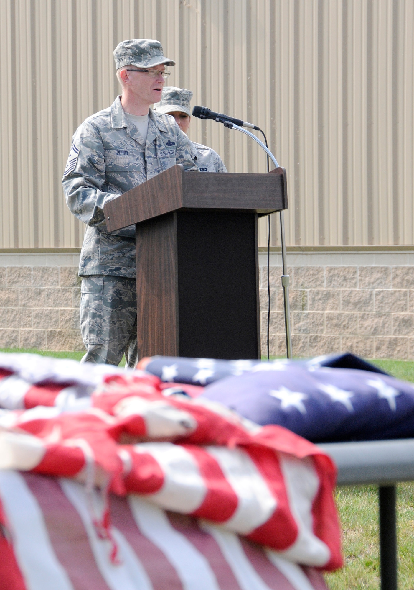 During a flag retirement ceremony held on base June 9, Senior Master Sgt. Dale Perry, a first sergeant at the 193rd Special Operations Wing, explains the history of the U.S. flag and urges military members and guests at the event to pay it proper reverence. (U.S. Air National Guard photo by Staff Sgt. Susan Penning/Released)