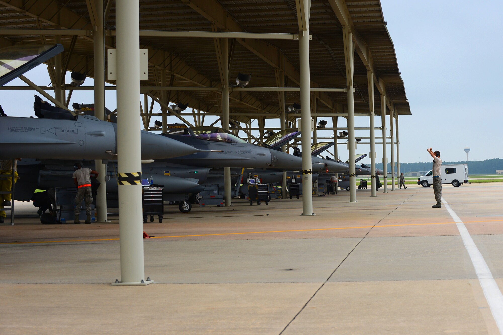 U.S. Air Force 77th Fighter Squadron crew chiefs recover an F-16 Fighting Falcon at Shaw Air Force Base, S.C., June 5, 2013. The  77th crew chiefs work around-the-clock, launching and recovering F-16s for training and real-world combat scenarios. (U.S. Air Force photo by Airman 1st Class Nicole Sikorski/Released)  