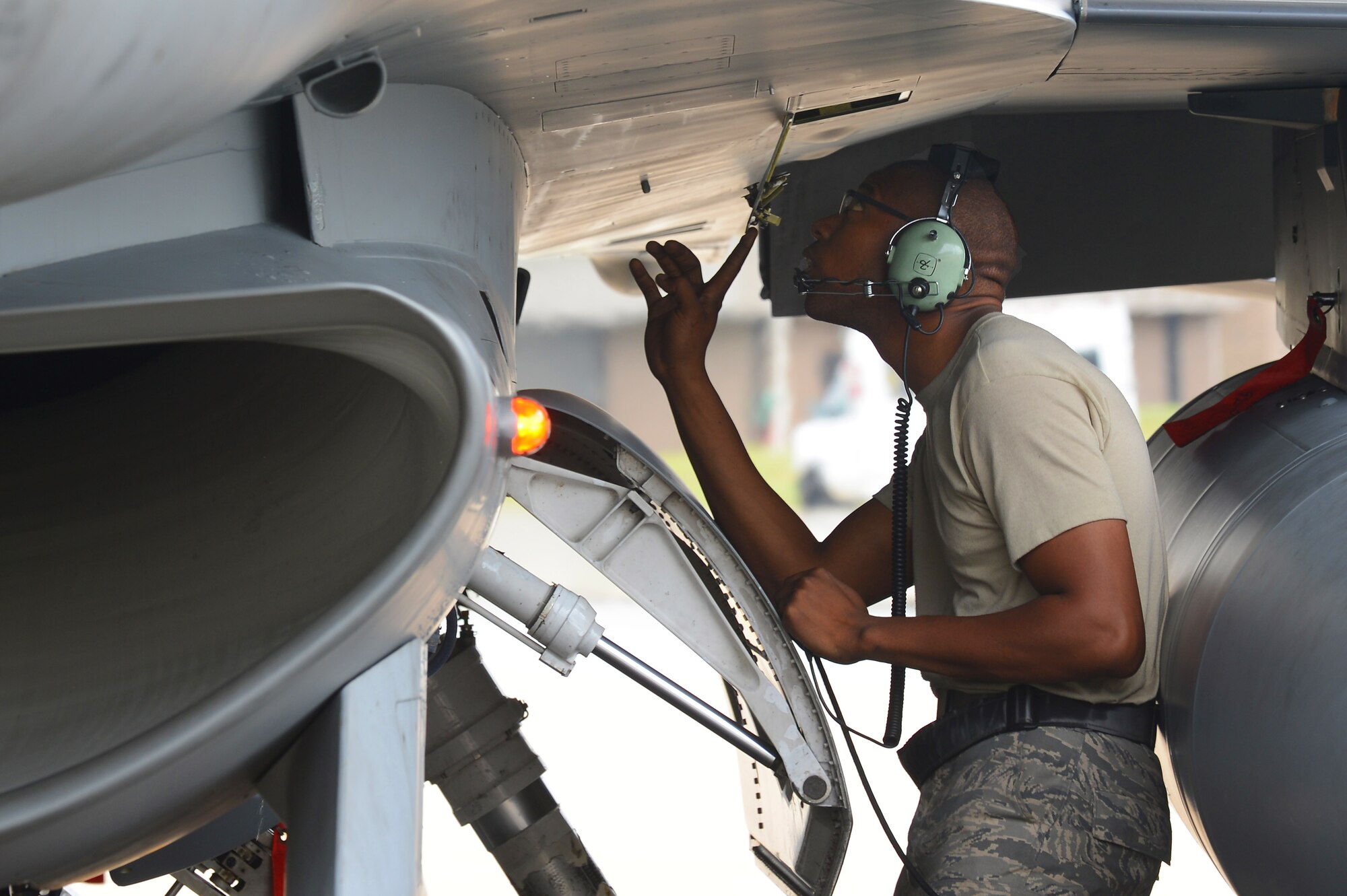 U.S. Air Force Staff Sgt. Edward Watkins, 77th Fighter Squadron crew chief, inspects an F-16 Fighting Falcon after recovering it at Shaw Air Force Base, S.C., June 5, 2013. The 77th crew chiefs work around-the-clock, launching and recovering F-16s for training and real-world combat scenarios. (U.S. Air Force photo by Airman 1st Class Nicole Sikorski/Released).  