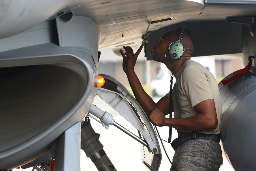 U.S. Air Force Staff Sgt. Edward Watkins, 77th Fighter Squadron crew chief, inspects an F-16 Fighting Falcon after recovering it at Shaw Air Force Base, S.C., June 5, 2013. The 77th crew chiefs work around-the-clock, launching and recovering F-16s for training and real-world combat scenarios. (U.S. Air Force photo by Airman 1st Class Nicole Sikorski/Released).  