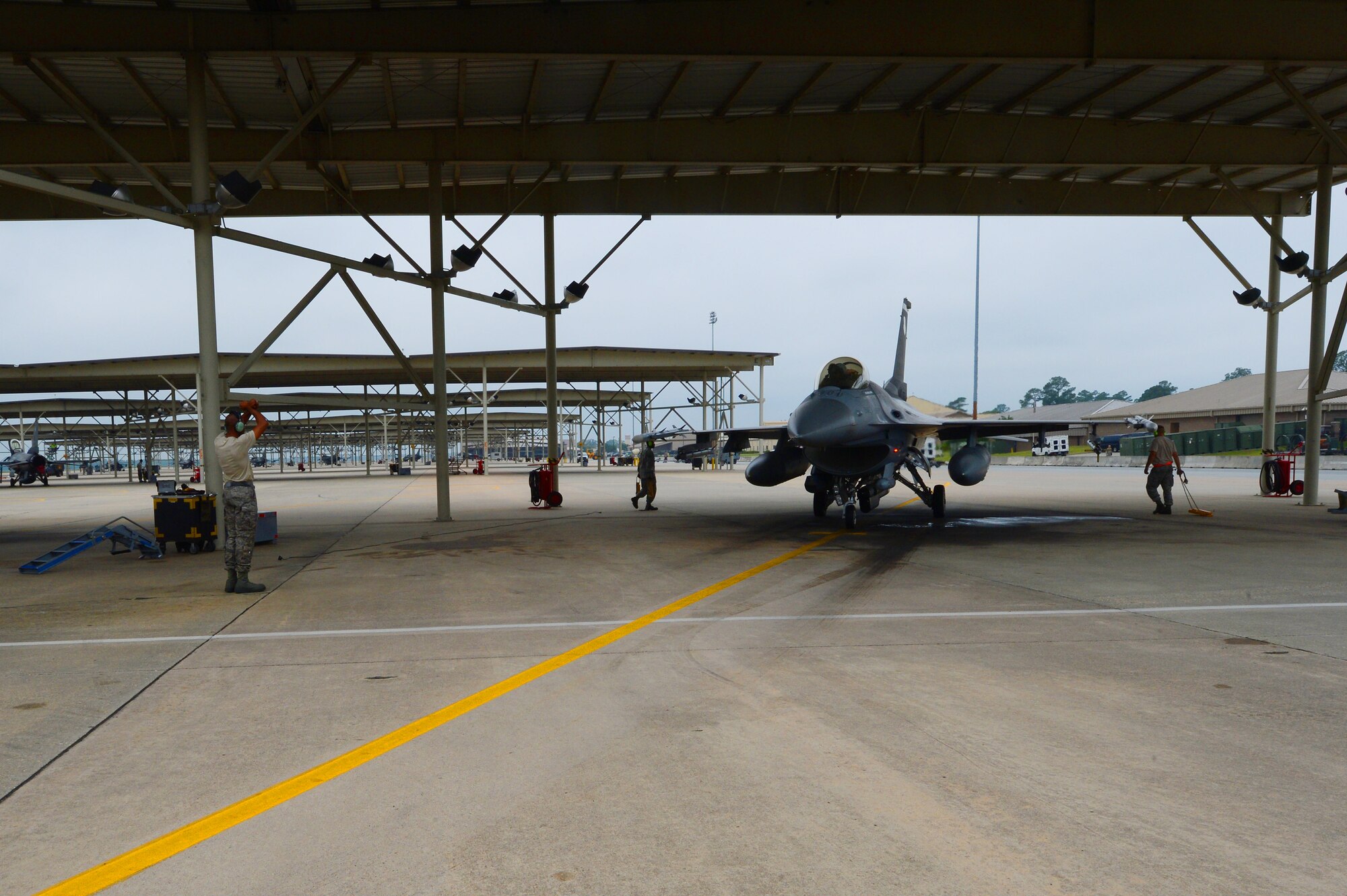 U.S. Air Force 77th Fighter Squadron crew chiefs recover an F-16 Fighting Falcon at Shaw Air Force Base, S.C., June 5, 2013. The 77th crew chiefs work around-the-clock, launching and recovering F-16s for training and real-world combat scenarios. (U.S. Air Force photo by Airman 1st Class Nicole Sikorski/Released)  