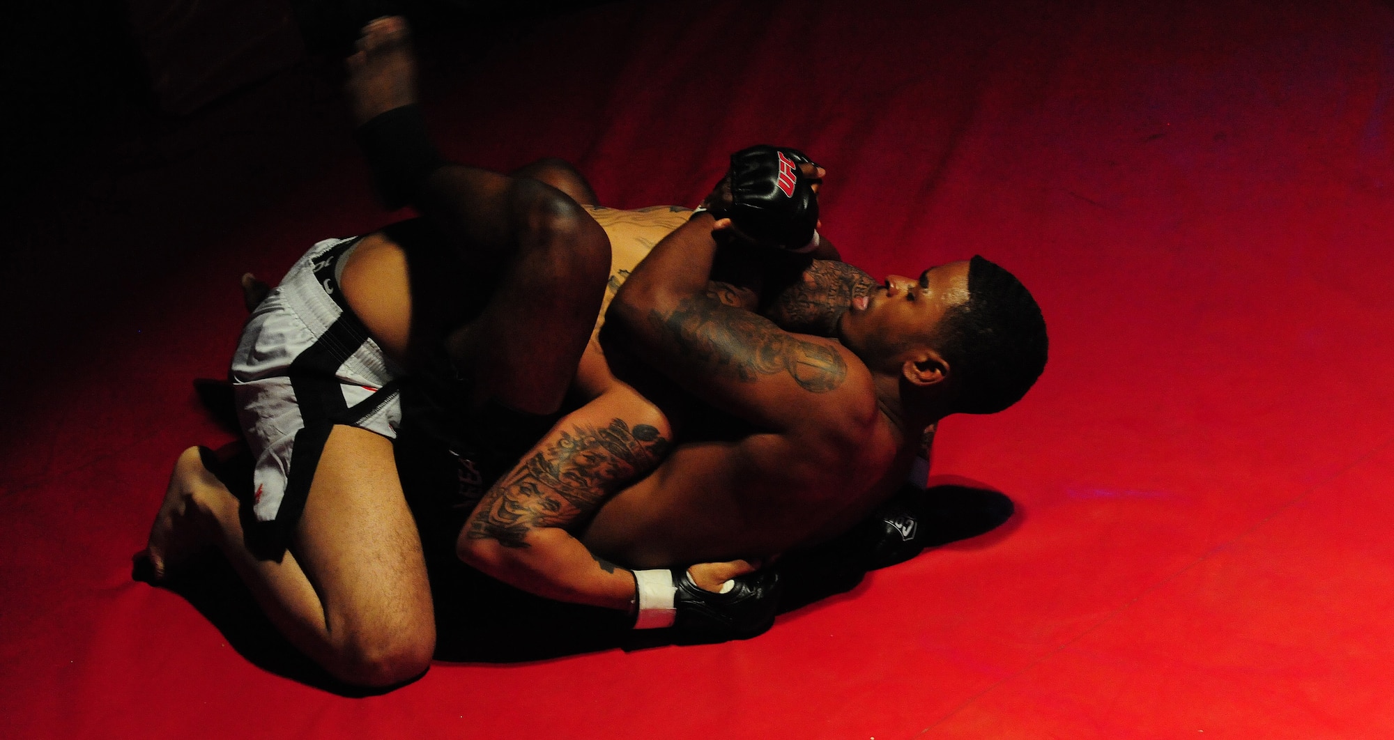Steven Dickerson, bottom, 509th Maintenance Squadron, performs a grappling technique on Chalen Chaney, during an amateur mixed martial arts match at Bottoms Up in Sedalia, Mo., May 18, 2013. Mixed martial arts blends a variety of techniques from other combat sports including wrestling, boxing, judo, kung fu, mao-thai and taekwondo. (U.S. Air Force photo by Staff Sgt. Nick Wilson/Released)