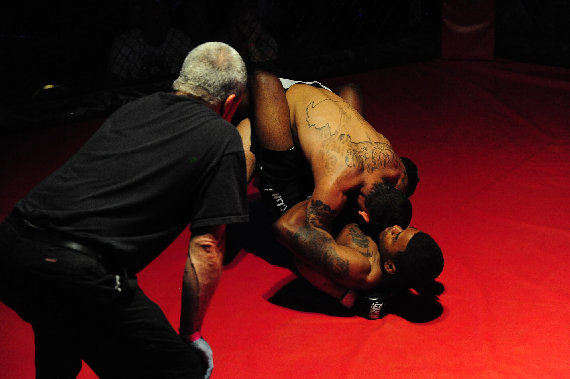 Steven Dickerson, 509th Maintenance Squadron, defends from the bottom as Chalen Chaney fights from the half- mount position during an amateur mixed martial arts match at Bottoms Up in Sedalia, Mo., May 18, 2013. Dickerson has been training on various mixed martial arts techniques, including jiu-jitsu, judo, hand-to-hand combat and grappling. (U.S. Air Force photo by Staff Sgt. Nick Wilson/Released)