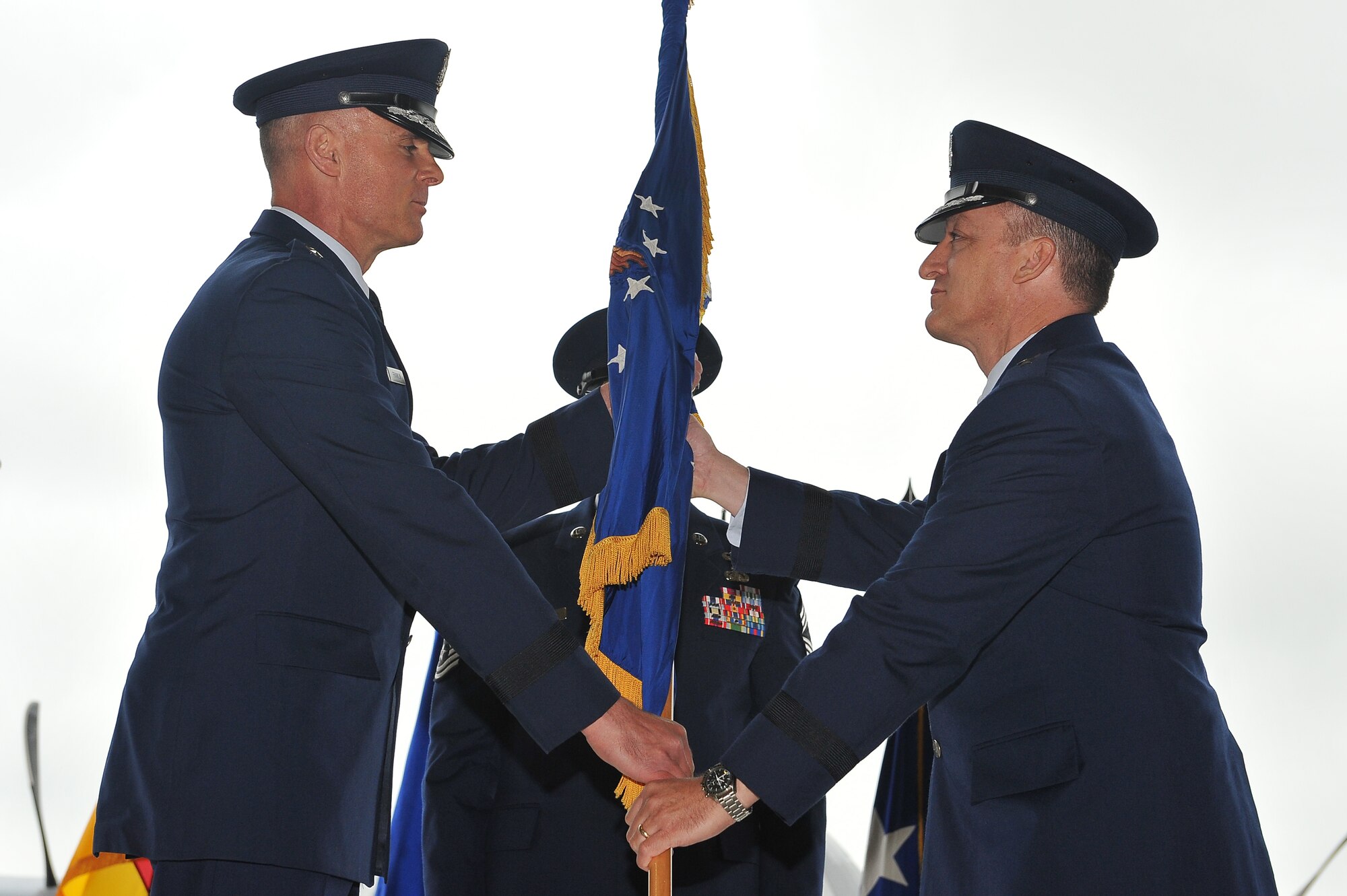 Brig. Gen. Patrick X. Mordente, (right) 86th Airlift Wing commander, takes the 86th AW guidon from Lt. Gen. Craig A. Franklin, 3rd Air Force commander, during the change of command ceremony, June 10, 2013, Ramstein Air Base, Germany. Mordente assumed command of the largest wing in Europe from Brig. Gen. C.K. Hyde, outgoing 86th Airlift Wing commander. (U.S. Air Force photo/Airman 1st Class Dymekre Allen)