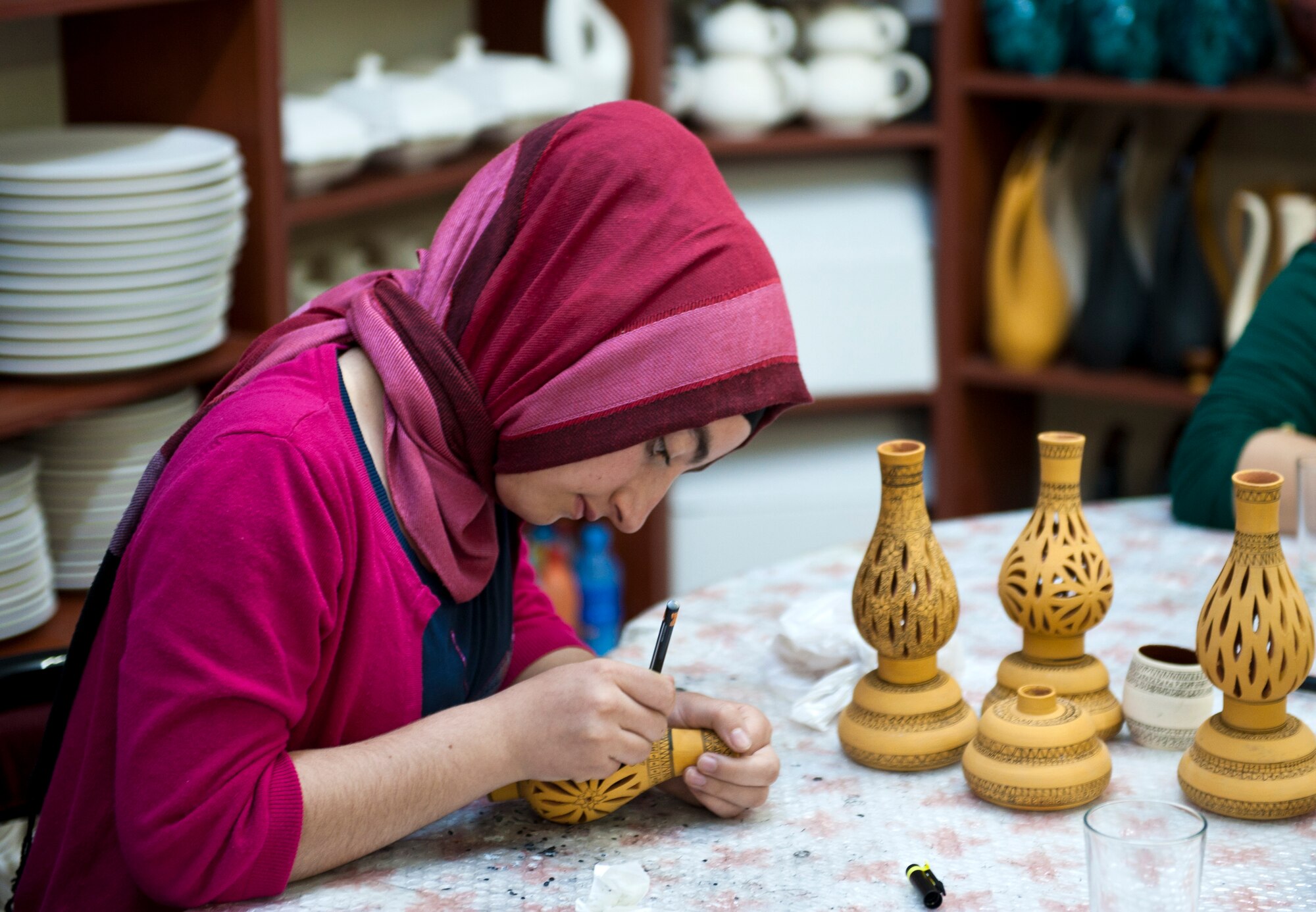 A Turkish woman details pottery in a ceramics shop May 5, 2013, at Avanos, Turkey. The ceramic trade in the city of Avanos dates back to the Hittites civilization. The Hittites were an ancient Anatolian people whose empire was established around 18th century B.C. and came to an end around 1180 B.C. as they splintered into city-states. (U.S. Air Force photo by Senior Airman Daniel Phelps/Released)