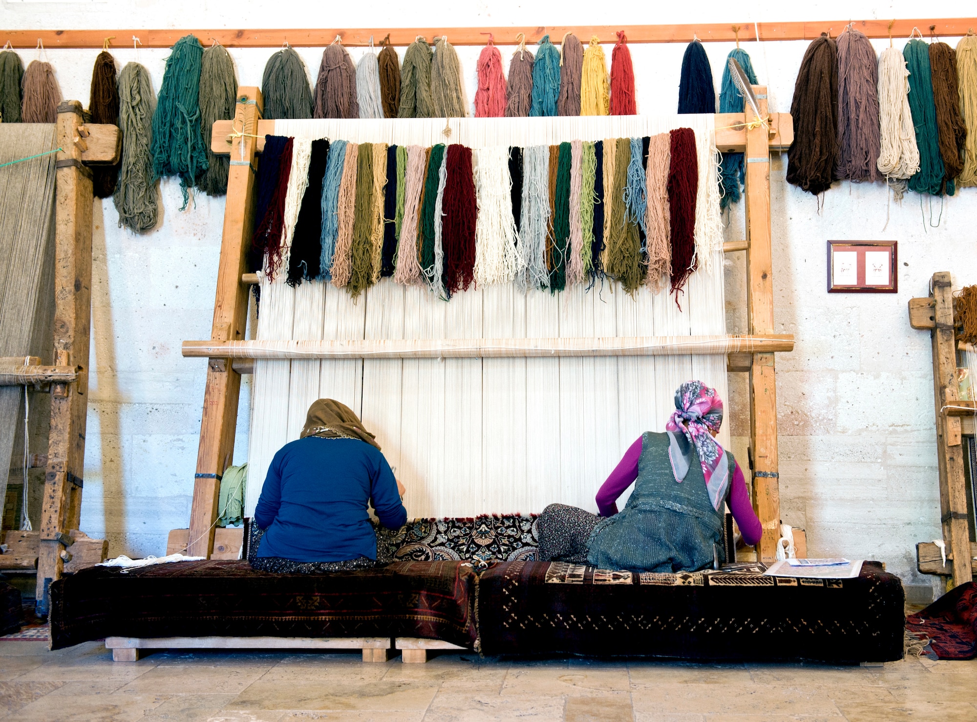 Turkish women tie knots on a weave to create a carpet May 5, 2013, in Goreme, Turkey. Turkish rugs are made in a wide variety of styles originating from the various regions in Anatolia. (U.S. Air Force photo by Senior Airman Daniel Phelps/Released)