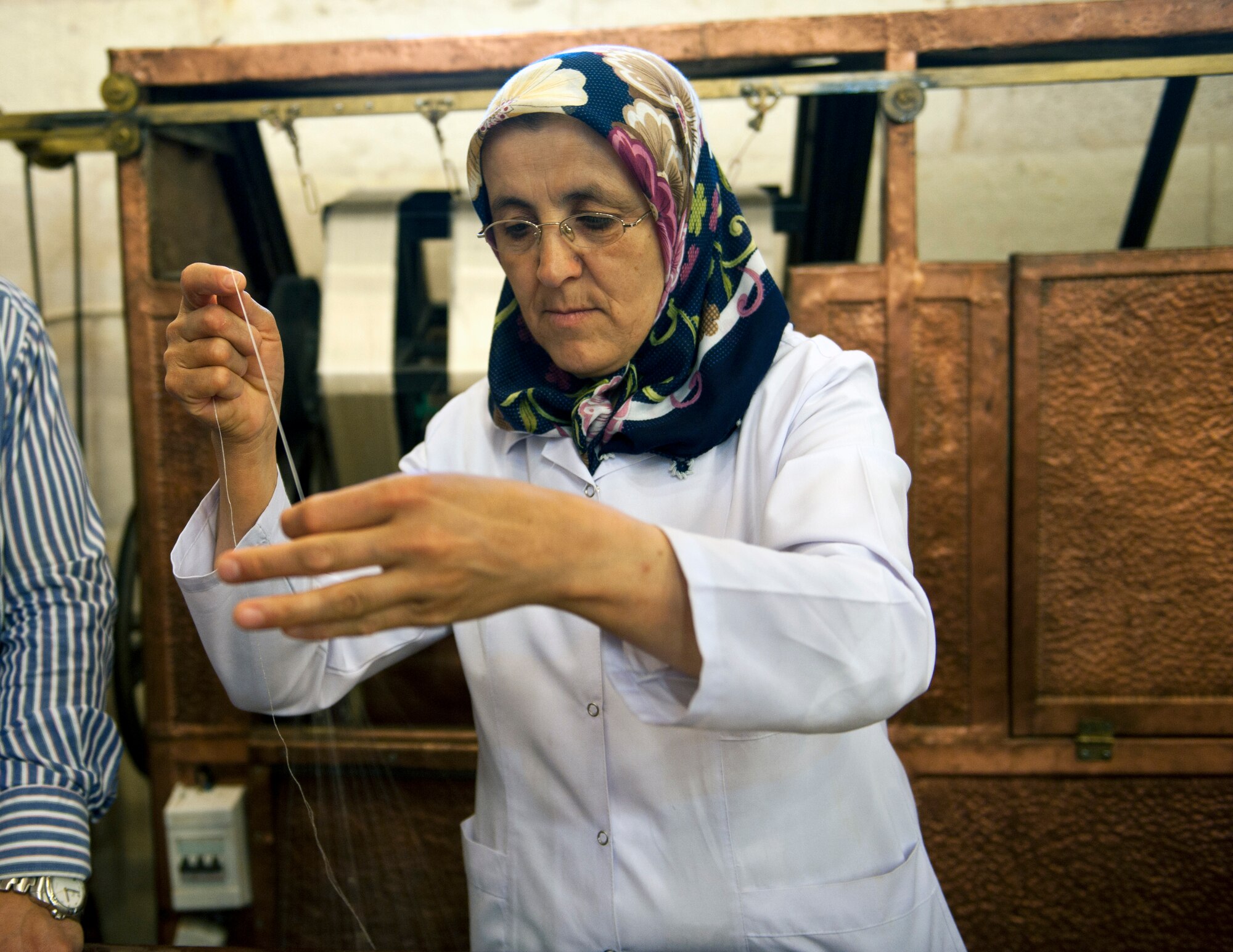 A Turkish woman spins silk for carpets May 5, 2013, in Goreme, Turkey. Turkish carpets are among the most well known and established hand-crafted art works in the world. (U.S. Air Force photo by Senior Airman Daniel Phelps/Released)