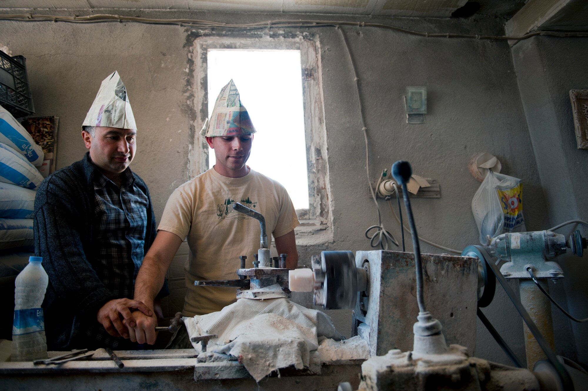 Staff Sgt. Chris Bedics, 39th Medical Support Squadron medical lab technician, is instructed by a local shop owner on how to shape onyx May 5, 2013, in the Cappadocia region of Turkey. Onyx is a volcanic stone with various colors and minerals. Cappadocia contains onyx deposits from the region’s past volcanic activity. (U.S. Air Force photo by Senior Airman Daniel Phelps/Released)