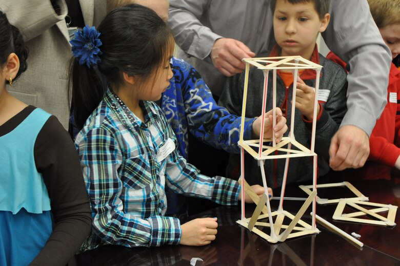 Children constructing buildings for the "Tower Building Contest” that was presented by Nathanael “Nate” Wales, civil engineer, Planning Division. 