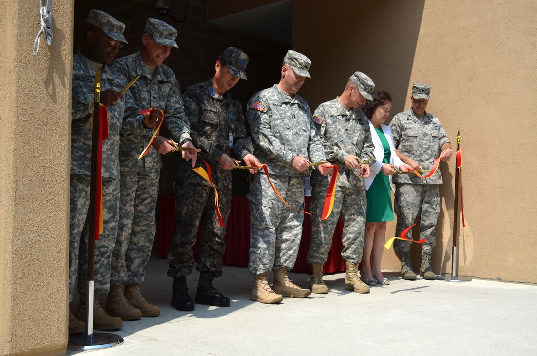 Soldiers of the 35th Air Defense Artillery Brigade and VIPs gathered for the ribbon cutting ceremony and grand opening of the new
brigade headquarters here, June 7. Maj. Gen. Walter Golden, Eigth Army Deputy Commanding General for Operations and Col. Don Degidio, Commander Army Corps of Engineers Far East District attended the event which showcased
the brigade's new operational headquarters.