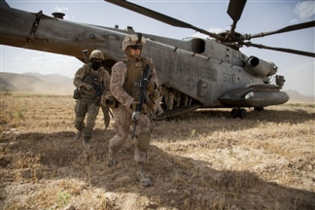 U.S. Navy Petty Officer 3rd Class Cameron Kirk exits a U.S. Marine Corps CH-53E Super Stallion helicopter during Operation Nightmare in Now Zad in the Helmand province of Afghanistan on June 5, 2013.  Operation Nightmare is a clearing operation led by Afghan National Security Forces and supported by U.S. Marines.  Kirk is a Navy hospital corpsman attached to Fox Company, 2nd Battalion, 8th Marine Regiment, Regimental Combat Team 7.  