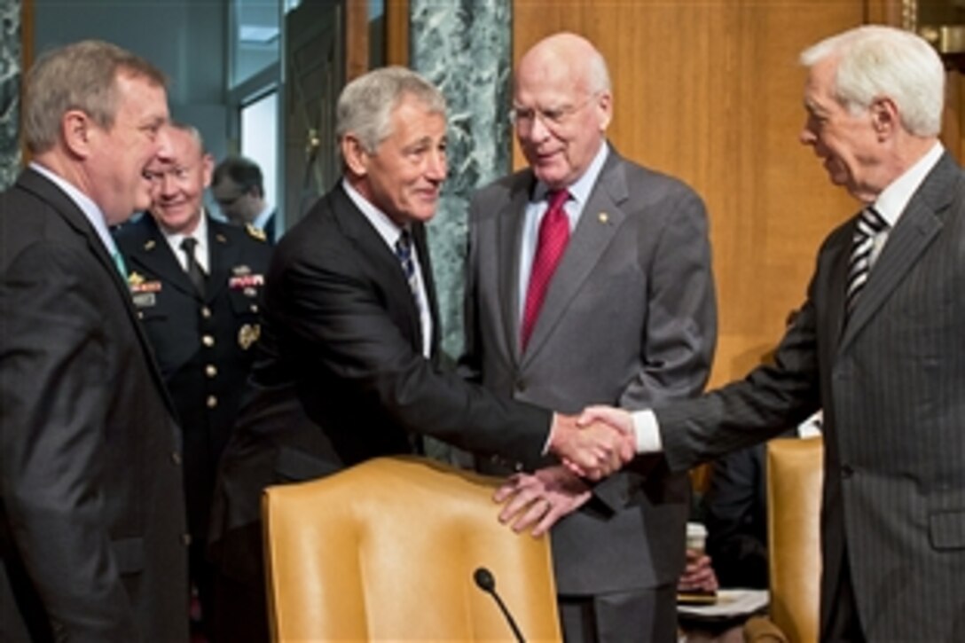 Defense Secretary Chuck Hagel talks with U.S. Sen. Thad Cochran of Mississippi, vice chairman of the Senate Appropriations Committee's defense subcommittee, before testifying in front of the subcommittee in Washington, D.C., June 11, 2013.