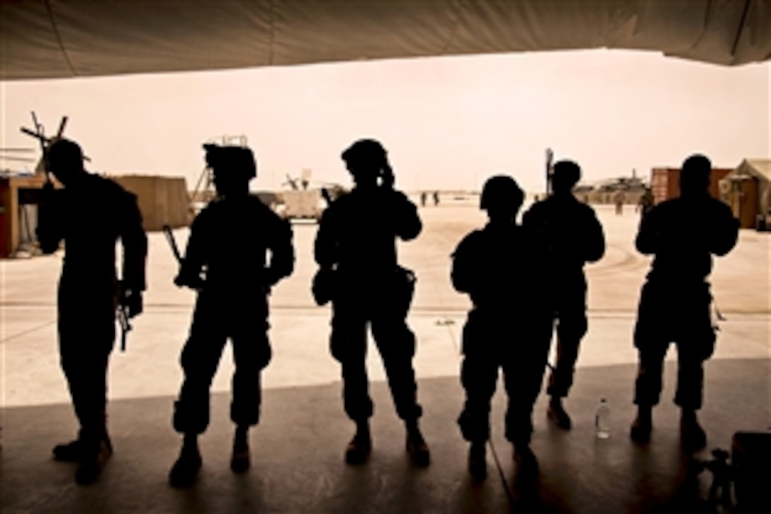 U.S. Marines check their radios on Camp Bastion in Afghanistan's Helmand province, June 6, 2013, before conducting a clearing operation. Afghan soldiers led the operation and the U.S. Marines supported it as part of an overall effort in which U.S. and coalition troops are working with Afghan forces to transition to Afghan-led operations in the country.