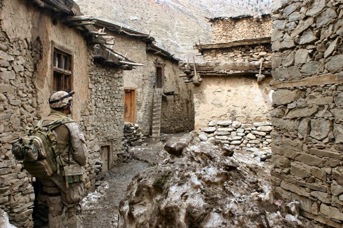 Petty Officer 2nd Class Alonzo Gonzales, a Hospital Corpsman with Kilo Company, 3rd Battalion, 3rd Marine Regiment, walks through an alley looking for signs of sickness or disease during a Marine operation in Afghanistan. He is wearing the Marine Corps combat utility uniform with its unique Marine digital pattern. Marine Corps Systems Command and the Army Natick Soldier Research, Development and Engineering Center received the 2013 Millson Award from the American Association of Textile Chemists and Colorists for the uniform's design and innovations. 