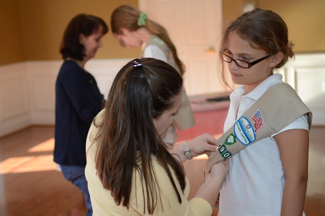 Sierra, 12, accepts one of many awards she earned throughout the year as a Cadette Girl Scout Troop 6890 Marine Corps Base Quantico cadette from her Assistant Troop Advisor Rachel Johnson during an awards ceremony at the Lincoln Housing party room on Marine Corps Base Quantico June 5, 2013.