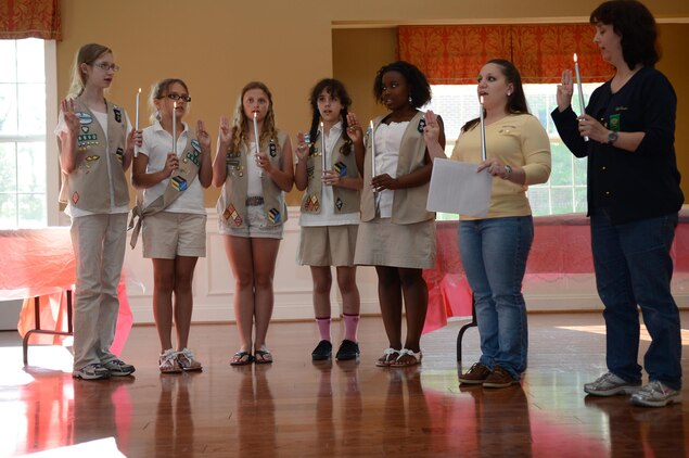 The Cadette Girl Scout Troop 6890 Marine Corps Base Quantico say their pledge as they accept their Girl Scout Silver Award June 5, 2013 during an awards ceremony at the Lincoln Housing party room on Quantico. They earned the award for their project, “Bringing Our Community Together.”