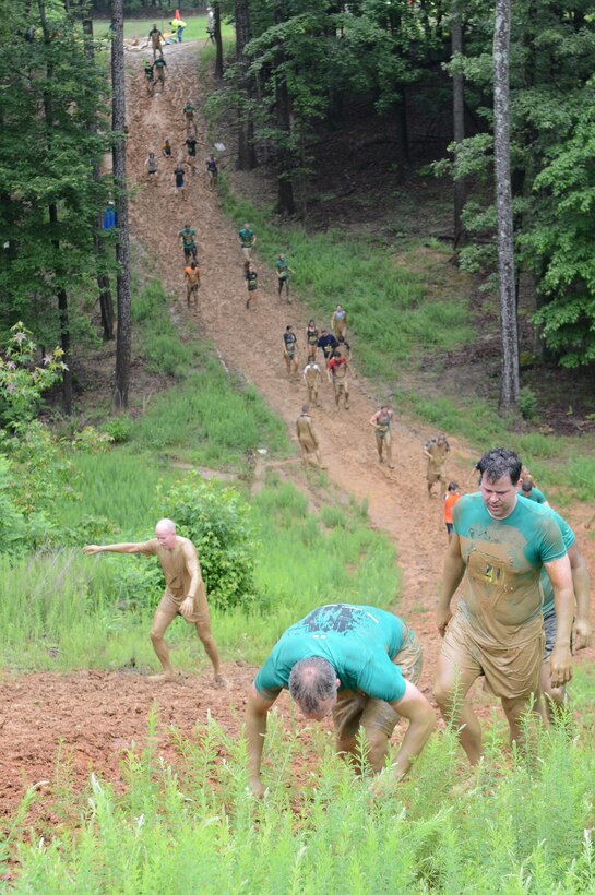 Participants in the Marine Corps Marathon's Run Amuck event run or walk up the final hill June 8, 2013. More than 3,000 people participated in the 3.5-mile Run Amuck race around Marine Corps Base Quantico. Participants ran though the woods, over the hills and into mud pits.