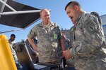 Chief of the National Guard Bureau Gen. Craig McKinley (center) receives a briefing on mobile communications systems from Sgt. Bernard Fuller of the Florida Army National Guard during a visit to the Robert Ensslin Armory in St. Augustine, Fla., Dec. 2, 2008. Gen. McKinley was in St. Augustine for the Region III Adjutant's General conference, and visited the Florida National Guard's Joint Operations Center Tuesday for a briefing on the state's emergency operations capabilities.