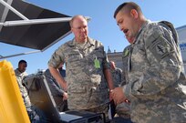 Chief of the National Guard Bureau Gen. Craig McKinley (center) receives a briefing on mobile communications systems from Sgt. Bernard Fuller of the Florida Army National Guard during a visit to the Robert Ensslin Armory in St. Augustine, Fla., Dec. 2, 2008. Gen. McKinley was in St. Augustine for the Region III Adjutant's General conference, and visited the Florida National Guard's Joint Operations Center Tuesday for a briefing on the state's emergency operations capabilities.