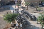 Members of the 39th Infantry Brigade Combat Team stand in formation during a transfer of authority ceremony in Baghdad Iraq Dec. 1. The ceremony marks the end of the 39th's second deployment in support of Operation Iraqi Freedom and symbolizes the brigade's transition of authority to the Texas Army National Guard's 56th Infantry Brigade Combat Team.